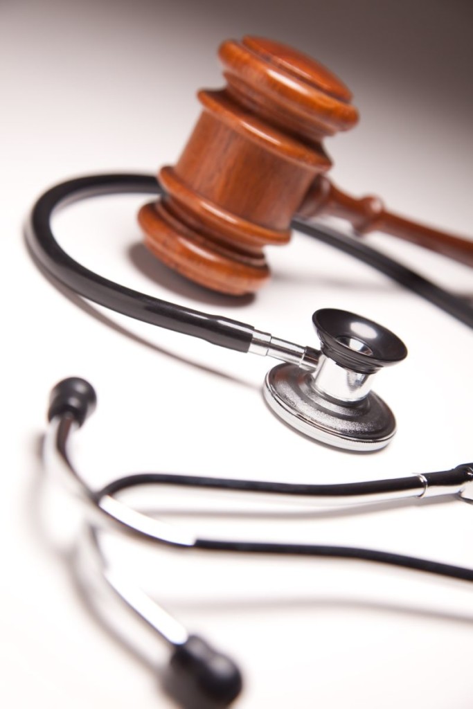Gavel And Stethoscope On Gradated Background