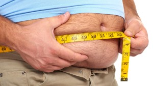 Fat man holding a measuring tape. Weight Loss.